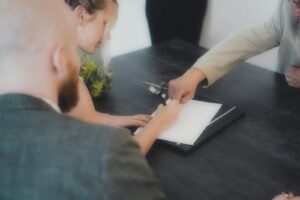Client signing a document in front of a notarial services attorney after showing proof of identity